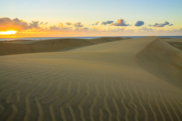 Fototapeta na wymiar Rippled and smooth sand of dunes of Maspalomas in Gran Canaria.