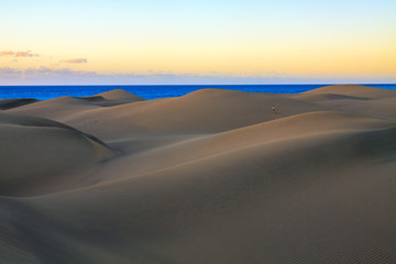 Fototapeta na wymiar Rippled and smooth sand of dunes of Maspalomas in Gran Canaria.