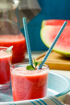 Fresh watermelon smoothies, glasses is standing on wooden table.