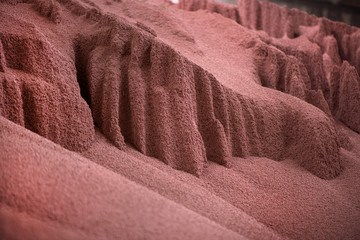 Shot of mixed chemical, artificial nitrogen plant fertilizer granules in factory. Big heaps of...