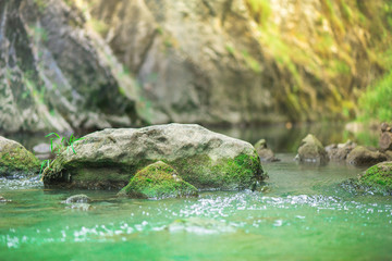  Small mountain waterfall on the rocks covered with moss deep in the forest. Cliffs in Cheile Turzii, Romania. Autumn is coming. Beautiful, calming nature background.