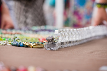 Engagement rings in boxes in a row on colorful background. Expensive, luxury jewelry made of gemstones. Chalcedony stone wedding ring.