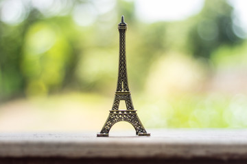 Eiffel model placed on a wooden table, background blurry