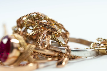 Real gold chain close up shot on gold rings and chain isolated on white background.