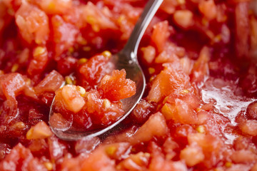 Crushed tomato. Red background.