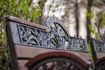 Wooden bench decorated with abstract ornaments in central park of Bucharest 