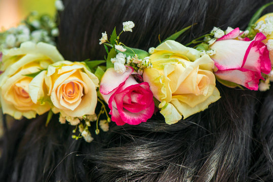 Female hair with beautiful colorful flower crown. Cheerful bride and bridesmaids party before wedding.