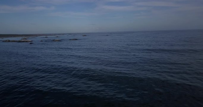 4K high quality aerial video footage of Western Cape's coast, Paternoster beach boulders, sandy sea front and Atlantic Ocean views in the background near Cape Town, South Africa on summer morning