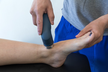 Electro stimulation used to treat pain, muscles injuries, strains and tension in hospital physiotherapy medical rehabilitation clinic for patient knee and leg.