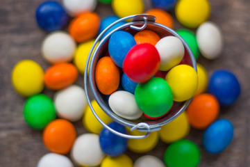 Colorful candy in a small metal bucket