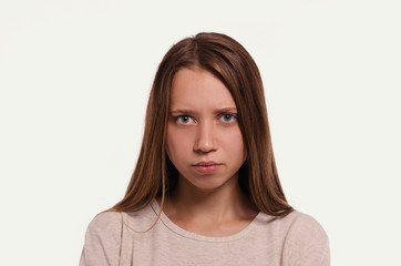 Fototapeta premium Attractive young girl portrait. Beautiful female looking at camera. Healthy woman studio portrait.