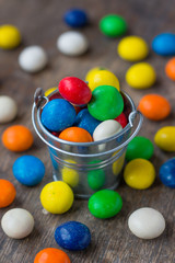 Fototapeta na wymiar Colorful candy in a small metal bucket