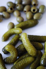 Gherkins and olives in a plate on the table  