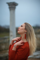 Young hot sexy woman in a short red dress outdoors