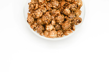 Photo of chocolate popcorn in glass Bowl on white background. copy space.