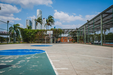 Fototapeta premium basketball and soccer court outdoor with city background