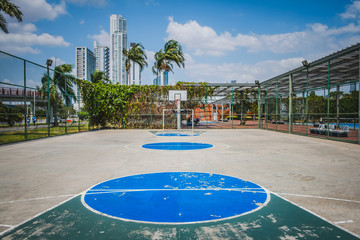 sports field, basketball court with city background