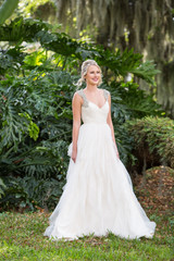 Beautiful Blonde Bride Portrait Smiling Outside in a Garden in Natural Light