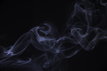 Smoke of a cigarette, on a black background