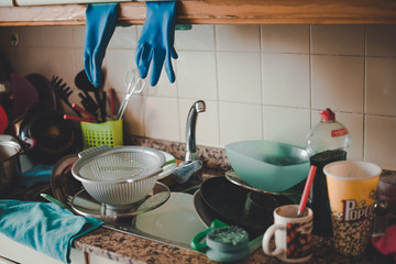 Messy countertop with dirty dishes in the sink