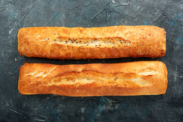 Italian ciabatta bread on dark background. top view