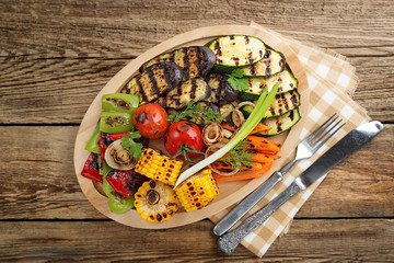 Delicious grilled vegetables on wooden background. top view