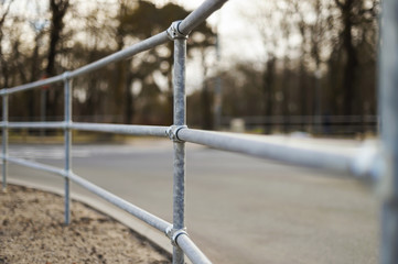 railing made of metal stainless steel pipes. Street. Fastening area with a bolt