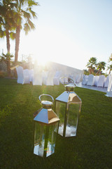 Lanterns with candle as a part of wedding decoration in garden on open air