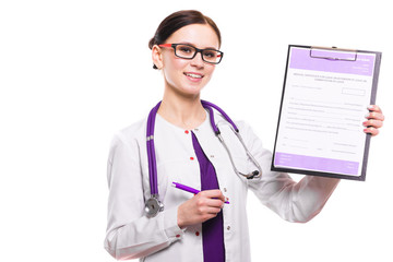 Young beautiful female doctor showing on clipboard with pen on white background