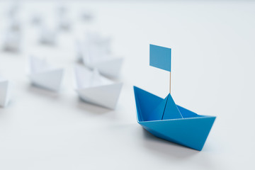Leadership concept with red paper ship leading among white on white background.3d rendering.