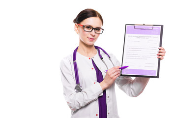 Young beautiful female doctor showing on clipboard with pen on white background