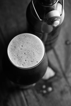 Stout beer in glass abd bottle on dark background