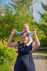 Mother keeps her son in her arms, and her son smiles