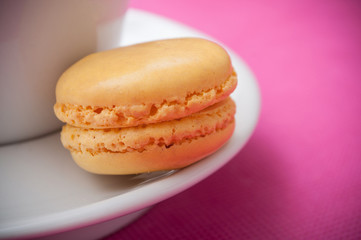 closeup of french macaron pastry on pink background