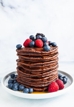 sweet American pancakes with fresh berries and sauce on the table