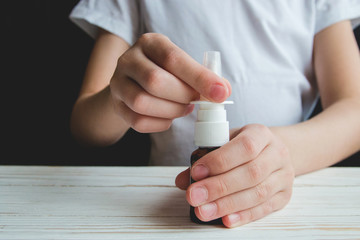 children's hands hold the nasal spray