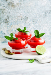 Berry Slushie with lime, Summer refreshing drink in serving glasses.