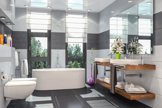 Modernes Badezimmer in weiß und schwarz mit Badewanne, WC, Bidet und zwei Waschbecken mit einem großen Spiegel