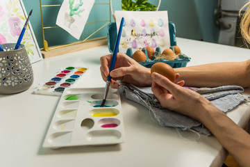Girl painting eggs for Easter