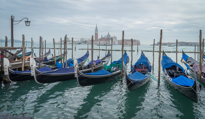 Fototapeta na wymiar Venise, Italy - 03 10 2018: Le grand canal, ses gondoles et l'église San Giorgio Maggiore en fond