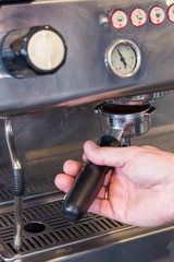 Barista locking portafilter with coffee in grouphead of coffee machine