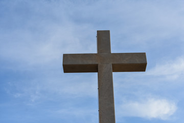 Catholic cross on the hills in Dubrovnik Croatia. Catholic symbol against blue sky 