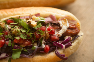 French bun sandwich with sausage and onion.
