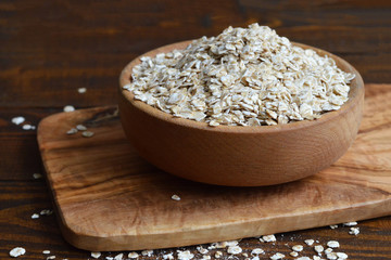 Oat flakes in wooden bowl