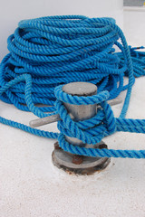 Fototapeta premium Blue rope on a white ship, mooring