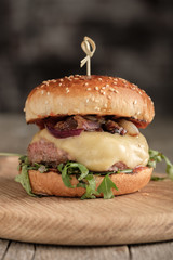 Homemade juicy burger with beef, cheese and caramelized onions. Street food, fast food