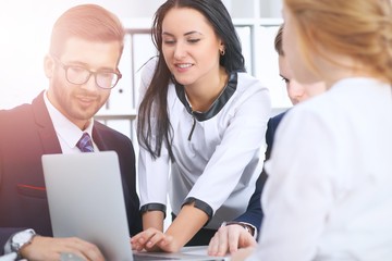 Obraz premium Business people at a meeting in the office. Focus on woman pointing into laptop