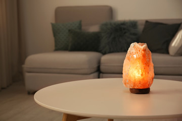 Himalayan salt lamp on table indoors