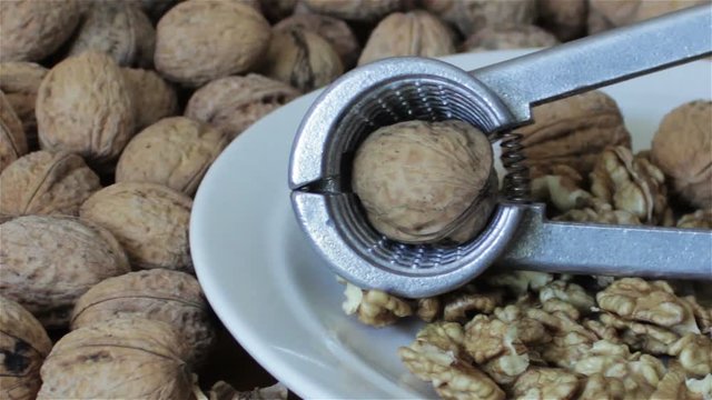 Walnut And Nutcracker Background Scene,On a wooden table walnuts lie with the Nutcracker