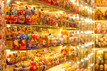 A lot of matreshkas at souvenir market shop. Different colors Russian dolls. Traditional classic Russian handicraft art background. Famous classical and modern russian dolls matreshka toys